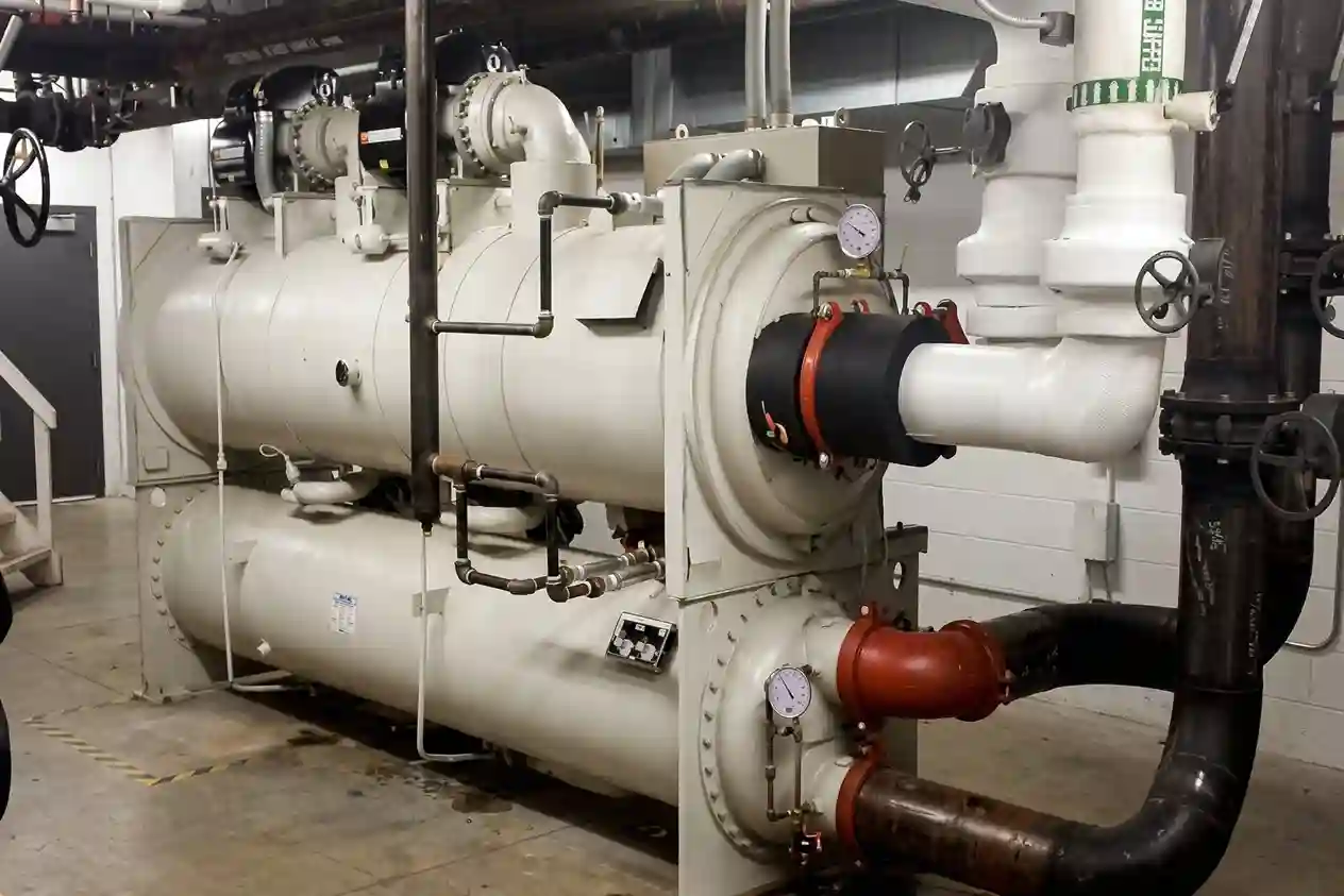 Industrial water chiller system with piping and compressors for commercial HVAC cooling and temperature control.
