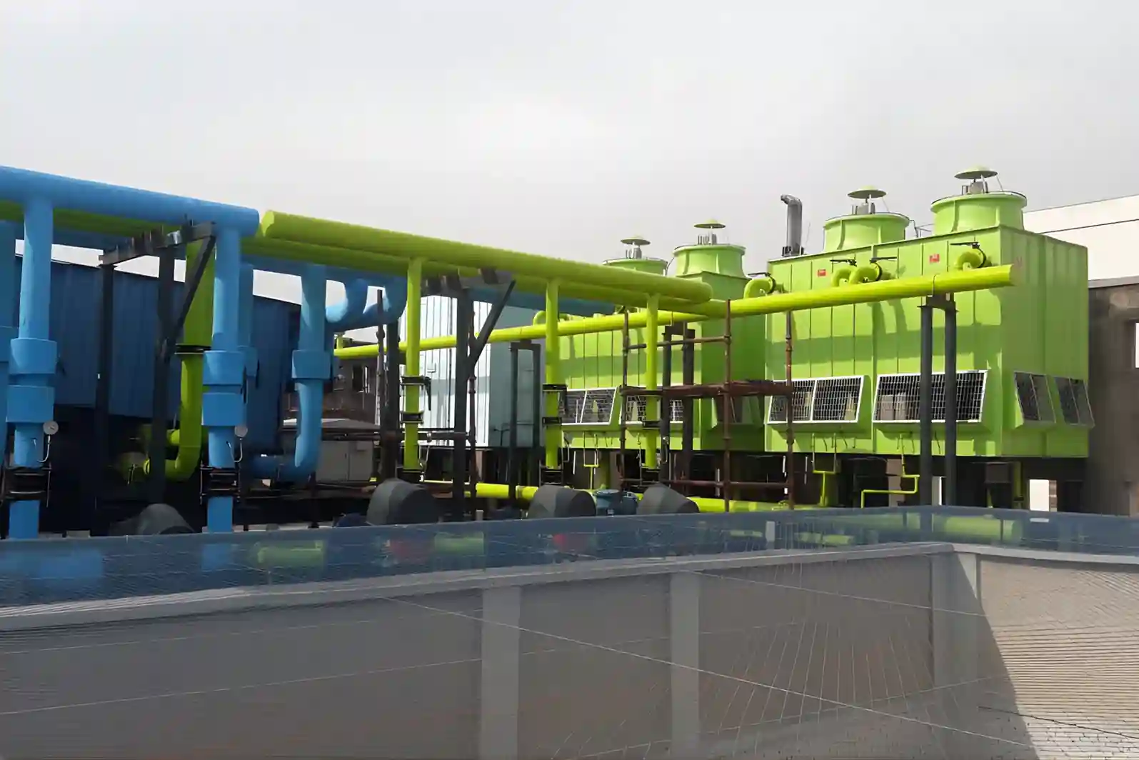 Large industrial HVAC cooling system with chillers, pipelines, and cooling towers for turnkey HVAC projects in Delhi NCR
