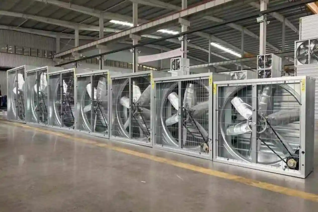 Row of industrial galvanized steel exhaust fans in a warehouse factory.